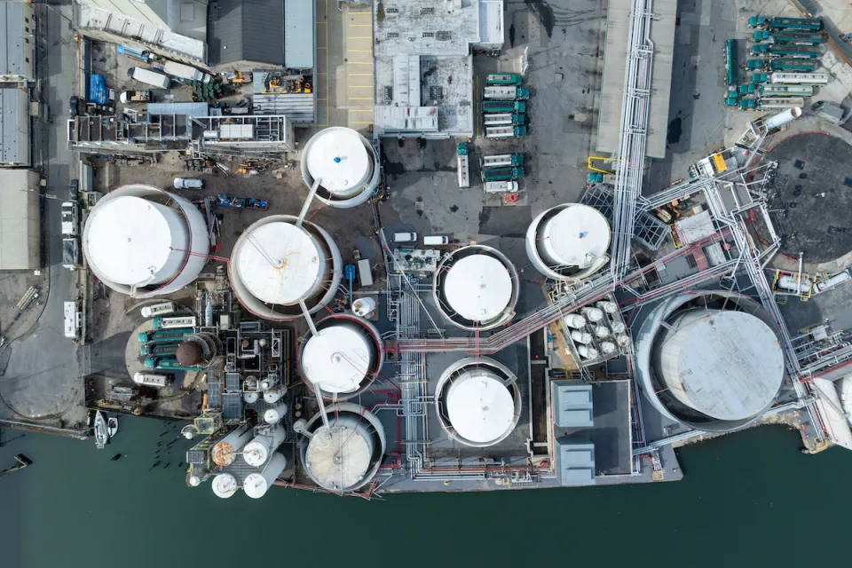 Bird's eye view of water treatment plant next to water body.
